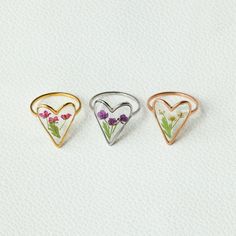 three heart shaped rings with flowers in them