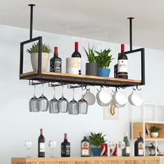 a shelf with wine glasses hanging from it