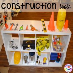 a white shelf with construction tools on it and the words construction tools written in large letters