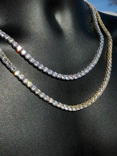 Gorgeous men's tennis chains.
Handmade
SOLID 925 Sterling Silver finished in rhodium or electroplated in 14k gold!
40-50ct man made diamonds...SO ICY THEY WILL BLIND YOU!
60-80 grams depending on length! Very heavy and solid weight
 
Never changes color! Why buy brass from others when you can get real solid silver with us!
LIFETIME GUARANTEE!
Chain lays flat and doesnt fold!

5mm thick
16-30" in length so you can wear as a choker or a longer chain!
 
Look great with a pend Gold Iced Out Round Tennis Necklace, Gold Iced-out Tennis Necklace, Classic Iced Out Tennis Necklace As Gift, Classic Iced Out Tennis Necklace Gift, Luxury Iced Out Tennis Necklace For Anniversary, Silver Iced Out Tennis Necklace For Anniversary, White Gold Iced Out Tennis Necklace For Anniversary, Iced Out White Gold Tennis Necklace For Anniversary, Mens Tennis