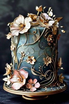 a blue and gold cake with flowers on it