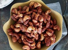 two bowls filled with nuts on top of a table