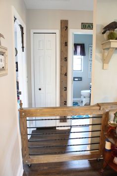 a room with a wooden stair case and a white door in the back ground area