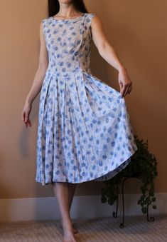 This adorable, classy, handmade dress is one of a kind!! The blue floral print, pleated skirt, and fitted top make this gem super sweet (and hard to let go of). I'm not positive what size this dress is, but my best guess is a US size 8 or 10 (I typically wear a size 6, and it's a little loose on me). It was hand-sewn in the late 1960s by my mom's friend's mother. I would love to give it a special home with someone who would love it as much as I do.  Dress is shown on a 150 lb, 5'10 female. Pleas Fitted A-line Dress With Accordion Pleats, Blue Floral Print Dress With Full Skirt, Fitted Floral Print Pleated Summer Dress, Blue A-line Dresses With Box Pleat, Fitted Pleated Dress With Box Pleat For Spring, Fitted Knee-length Pleated Dress With Box Pleat, Fitted Pleated Dress For Daywear, Summer Dresses With Box Pleat And Full Skirt, Fitted Summer Box Pleat Pleated Dress