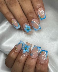 Click for More ➡️ | Save for Later ❤️  This playful nail design features bright blue French tips, paired with delicate white flower accents for a feminine touch. The clear base keeps the design light and airy, while the addition of glitter adds a subtle sparkle, perfect for those who want a fun, cheerful look with a bit of glam. (Blue French Florals with Glitter - Blue Nail Design Ideas) Cute Nails Blue And White, Summer Vacay Nails, Blue And White Nails, Blue Acrylic Nails, Blue Nail Designs, Blue Nail, Unique Acrylic Nails