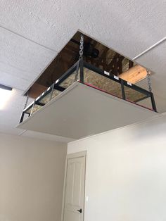 a room that has some kind of suspended object in it's ceiling and is being worked on