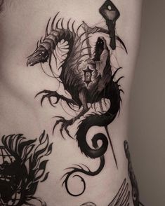 a woman's lower back with tattoos on her stomach and an image of a dragon