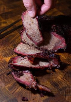 someone is slicing up some meat on a cutting board with the words smoked chuck roast