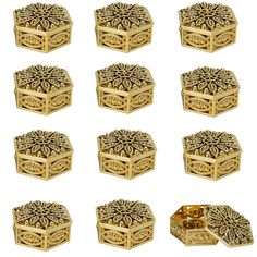 twelve gold boxes with intricate designs on each one, all in different shapes and sizes