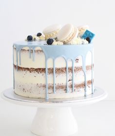 a white cake with blue icing and cookies on top