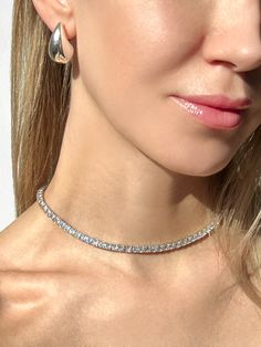 This elegant tennis necklace is crafted from 925 solid sterling silver and is studded with sparkling 4mm round-cut created diamonds for a total carat weight of 24.00-45.00TCW. The perfect accessory for any formal occasion, this necklace is both sophisticated and exclusive. This exquisite necklace has high polished rhodium finish that gives it a stunning shiny look that lasts for many years.Our created diamonds and gemstones are synthetic simulants (NOT natural/lab-grown/moissanite) that feature brighter D color , FL/VVS1 clarity and ideal cut making them visually indistinguishable from natural diamonds that cost thousands of dollars, but they don't pass the diamond test. We only use high quality solid gold/silver in our jewelry, WE DO NOT sell fake gold/silver jewelry. Every item, is shipp Round Tennis Necklace With Single Cut Diamonds Gift, Rose Gold Round Tennis Necklace As A Gift, Dazzling White Gold Tennis Necklace Gift, Dazzling Diamond White Tennis Necklace As A Gift, Dazzling Silver Diamond Cut Tennis Necklace, Dazzling Silver Tennis Necklace With Round Cut, Silver Dazzling Tennis Necklace, Silver Diamond Cut Tennis Necklace Gift, Dazzling Silver Round Cut Tennis Necklace