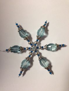 a snowflake made out of glass beads