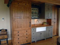 an old fashioned kitchen with wooden cabinets and drawers