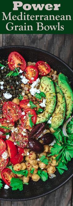 a platter filled with beans, tomatoes, avocado and other vegetables on top of a wooden table