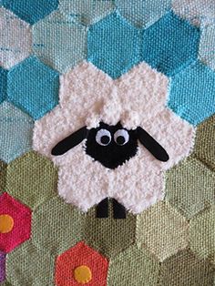 a close up of a sheep on a blanket