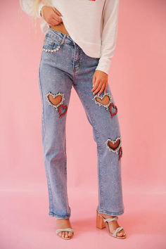 Get ready to rock the retro look with our ALL AMERICAN HEART JEANS! These mom jeans come in a medium wash and are adorned with unique heart cutouts, featuring red rhinestone outlines and heart patches. Stand out and make a statement with these quirky and fun jeans. Embroidered Jeans Outfit, Embellished Clothes, Pride 2024, Fun Jeans, Cowgirl Bride, Heart Jeans, Valentines Outfit, Pig Pen, Bling Jeans