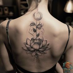 the back of a woman's neck with a flower and clock tattoo on it