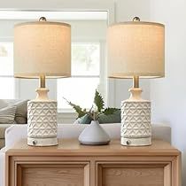 two lamps sitting on top of a wooden table