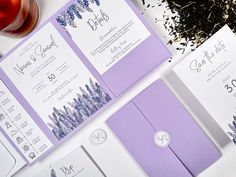 the wedding stationery is laid out on top of each other