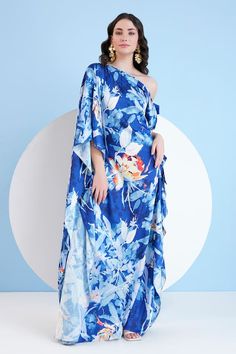 Blue draped one shoulder kaftan on a floral print base. - Aza Fashions Summer Evening Floral Print Kaftan, Blue Beach Dress With Asymmetrical Neckline, Blue Kaftan For Evening In Spring, Blue Kaftan For Spring Evening, Blue Evening Kaftan For Spring, Blue Summer Evening Kaftan, Blue Asymmetrical Neckline Beach Dress, Blue Long Kaftan With Floral Print, Blue Floral Embroidered Festive Kaftan