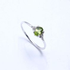 RING DETAIL Metal : 925 sterling silver Center stone : Peridot & cubic zirconia Shape : Oval Stone size; 6x4mm CUBIC ZIRCONIA We just utilize the best cubic zirconia. With shading, lucidity and phenomenal slice to coordinate common precious stone guidelines, our fine quality cubic zirconia gives the ideal degree of brightness, sparkle and fire. PERIDOT Peridot stones are birthstones for August, September and October... furthermore, make lovely valuable jewelry.Using Peridot gemstones Peridot wil Silver Peridot Birthstone Ring, Peridot Birthstone Ring In White Gold, Silver Peridot Promise Ring, Silver Peridot Ring With Birthstone, Silver Peridot Solitaire Ring, Silver Peridot Rings For Promise, Silver Ring With Peridot Birthstone, Green Crystal Birthstone Ring In Sterling Silver, Dainty Peridot Promise Ring