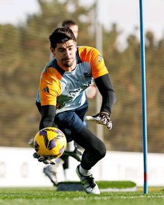 a soccer player is about to kick the ball