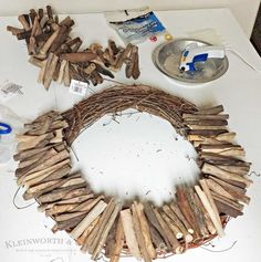 the wreath is made out of branches and wood pieces, along with other crafting supplies