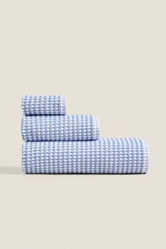 three blue towels stacked on top of each other