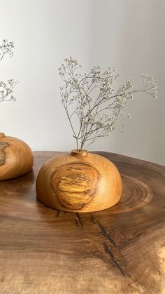 two wooden vases sitting on top of a table