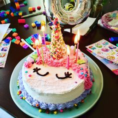 a birthday cake with candles and decorations on it