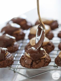 a cookie being drizzled with chocolate and peanut butter