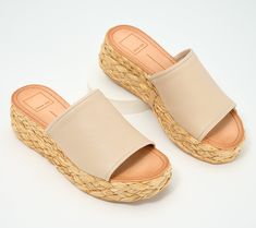 This fashionable flatform sandal pairs sleek leather with boho-chic raffia, creating a cool juxtaposition that's just as at home at the beach resort as it is in the city center. From Dolce Vita. Chic Straw Platform Sandals, Beach Straw Wedge Sandals With Cork-bed Midsoles, Beige Straw Wedge Sandals With Textured Sole, Leather Wedge Sandals For Spring Beach Occasion, Summer Sandals With Cork-bed Midsoles In Natural Color, Straw Sandals With Cork-bed Midsoles For Summer, Chic Platform Sandals For Beach, Chic Woven Leather Espadrilles For Beach, Leather Wedge Sandals For Summer Vacation