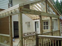 a wooden porch with a roof made out of wood