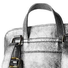 Looking for a versatile and stylish bag for everyday use? Look no further than this Pewter Convertible Metallic Leather Pocket Backpack, which can be worn as a backpack, over the shoulder, or carried by hand using the top handle. Crafted from pewter metallic leather, this backpack is both stylish and durable. Its interior is thoughtfully designed with separate compartments to keep your belongings organized and secure. The top of the backpack can be securely closed with a smooth-gliding zipper fo Leather Silver Satchel For Everyday Use, Modern Travel Backpack With Silver-tone Hardware, Leather Backpack With Silver-tone Hardware For Travel, Leather Travel Backpack With Silver-tone Hardware, Everyday Backpack With Silver-tone Hardware, Travel Backpack With Silver-tone Hardware, Silver Leather Shoulder Satchel, Modern Silver Bag With Detachable Strap, Modern Silver Bags With Detachable Strap