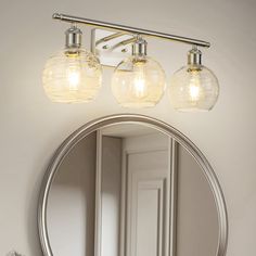 a bathroom vanity with two lights and a mirror