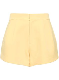 light yellow stretch-design pressed crease high-waisted concealed front fastening tailored cut two rear jetted pockets thigh-length Chic Yellow Shorts For Workwear, Yellow Summer Shorts For Work, Yellow Workwear Bottoms Shorts, Yellow Short Length Bottoms For Workwear, Yellow Short Bottoms For Work, Yellow Short Length Workwear Bottoms, Yellow Shorts For Workwear In Spring, Chic Fitted Yellow Shorts, Yellow Workwear Shorts For Spring