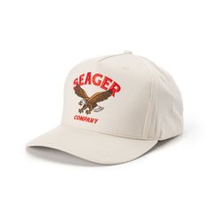 the seager company hat is white with an eagle and red lettering on the front