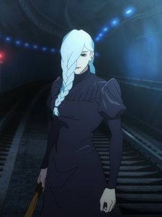 a woman with long white hair standing in front of a train track and looking at the camera