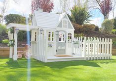 a small white wooden house with a porch