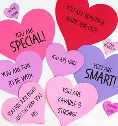 several heart shaped paper cards with words on them