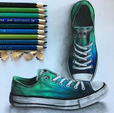 a drawing of a pair of shoes with colored pencils next to it