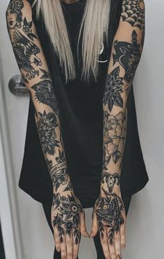 a woman with tattoos on her arms and hands