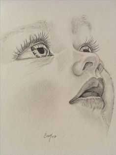 a pencil drawing of a child's face with the eyes open and tongue out