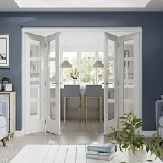 a living room with blue walls and white furniture