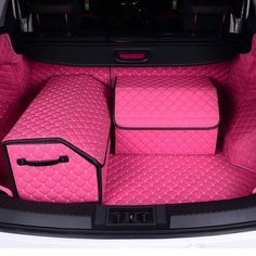 the interior of a car with pink carpeting and matching leather seats, including two suitcases