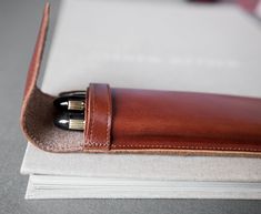 "Fountain Leather Pen Case is crafted with high quality, genuine top grain leather attached with fine and durable stitching, giving it a sleek look and a slim body. This Pen Case is designed with convenience in mind. Sleeve cover allows easy access to your pens. Durable - Made from durable materials and manufactured with durable and strong stitching to ensure that it has a long lasting life. Enough capacity to putting around 4pcs pencils or 3pcs large fountain pens, perfect for your daily use. W Classic Pencil Case With Pen Slots For Personal Use, Classic Pencil Case With Pen Slots As Gift, Modern Pencil Case With Pen Slots For Business, Modern Business Pencil Case With Pen Slots, Classic Leather Pencil Case For Personal Use, Classic Pencil Case With Pen Holders, Brown Leather Pencil Case Gift, Leather Rectangular Pencil Case As Gift, Leather Rectangular Pencil Case For Gift