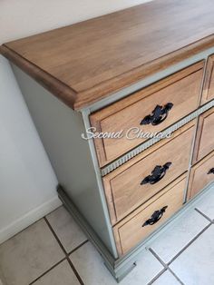 a wooden dresser with drawers on top of it