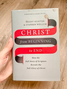 the book christ from beginning to end is being held by a person's hand