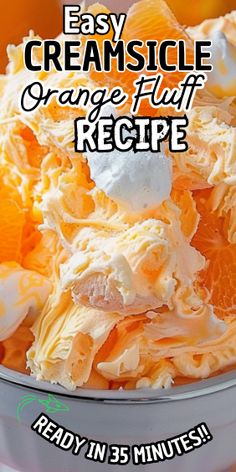 a bowl filled with oranges and whipped cream next to an orange slice on top of it