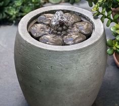 an outdoor fountain with rocks in it